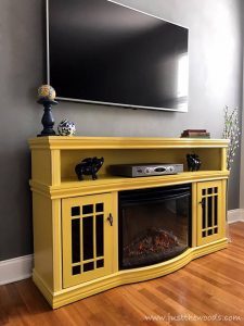 yellow-furniture-on-gray-wall, yellow painted furniture, electric fireplace, media center, new york