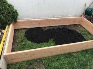 fill-garden-bed-with-soil, raised garden bed, outdoor planters, gardening with kids, how to build a garden bed