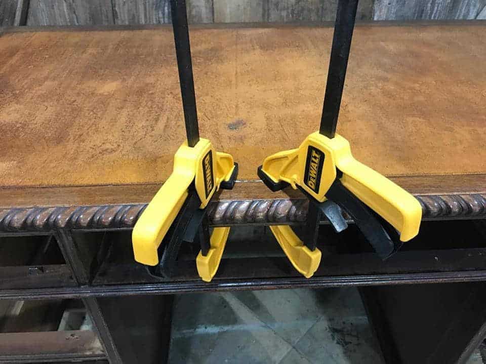 repair leather inlay / yellow dewalt trigger clamps / clamp leather to desk until glue dries