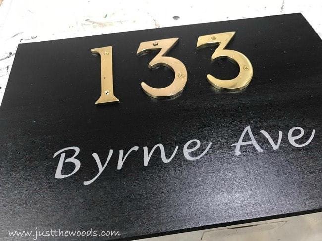 brass letters on black painted address plaque