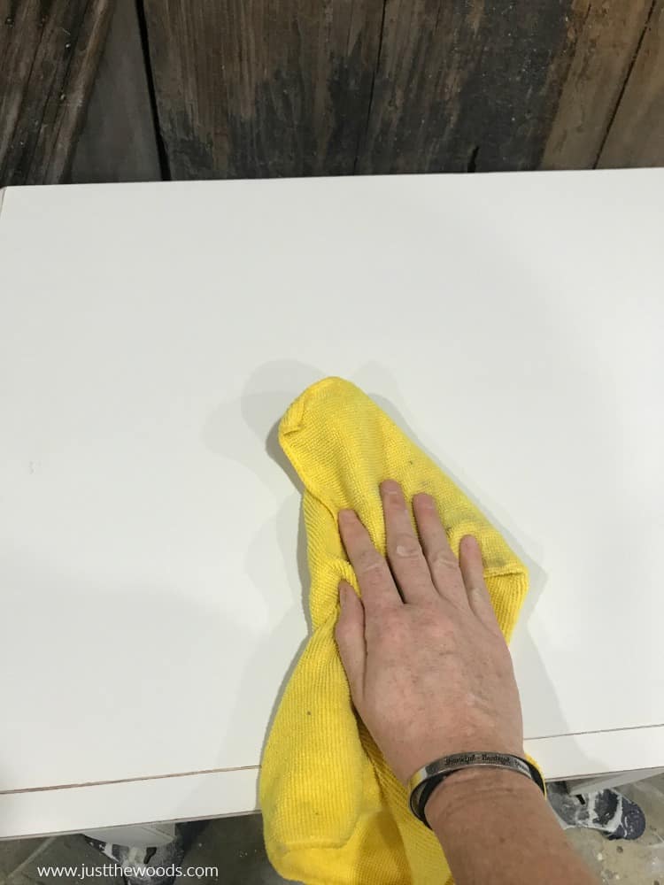 remove dust with lint free cloth, yellow cloth on cream chalk painted table