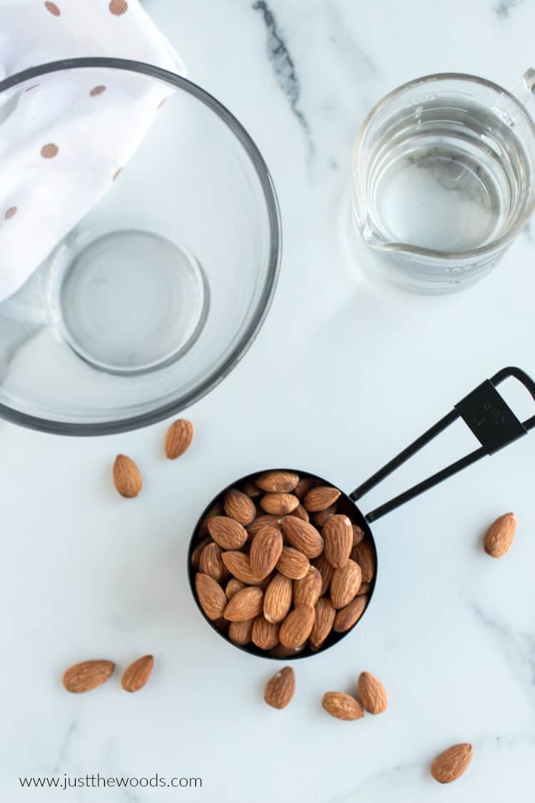 how to make almond milk, almonds in measuring cup with water