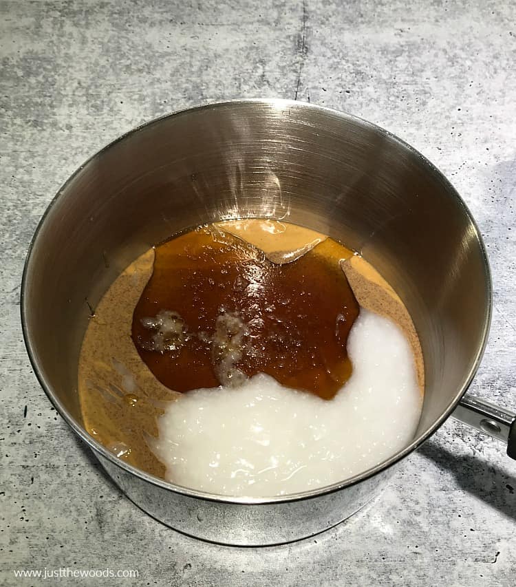 honey in pot with peanut butter and coconut oil for homemade oat bars