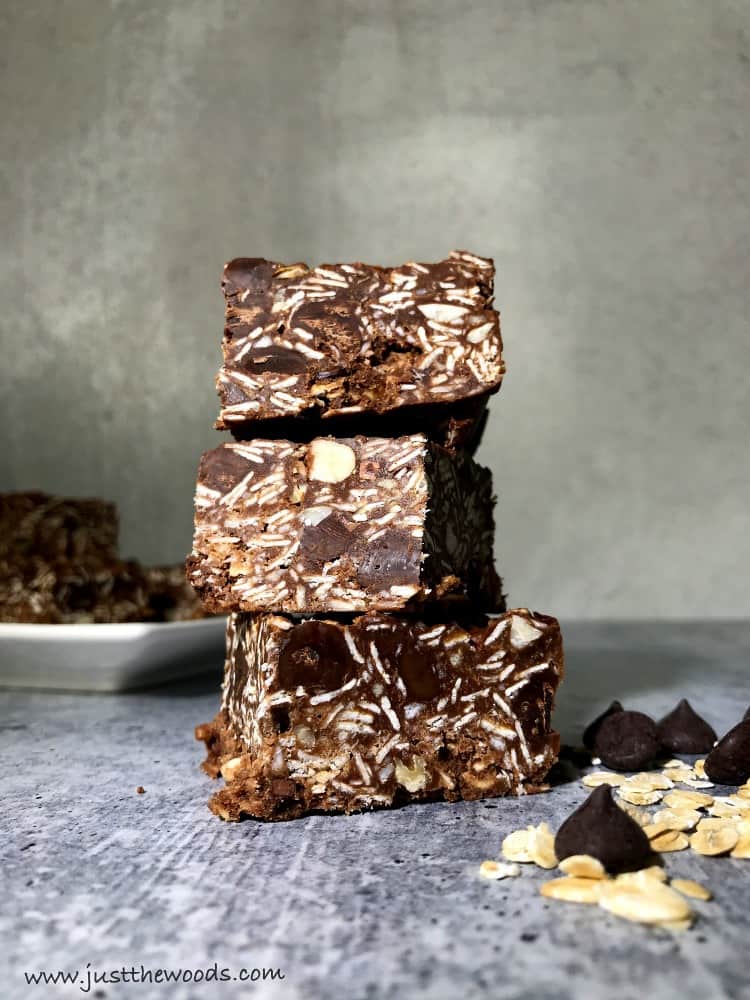 chocolate oat bars with nuts and peanut butter, gluten free, gray backround