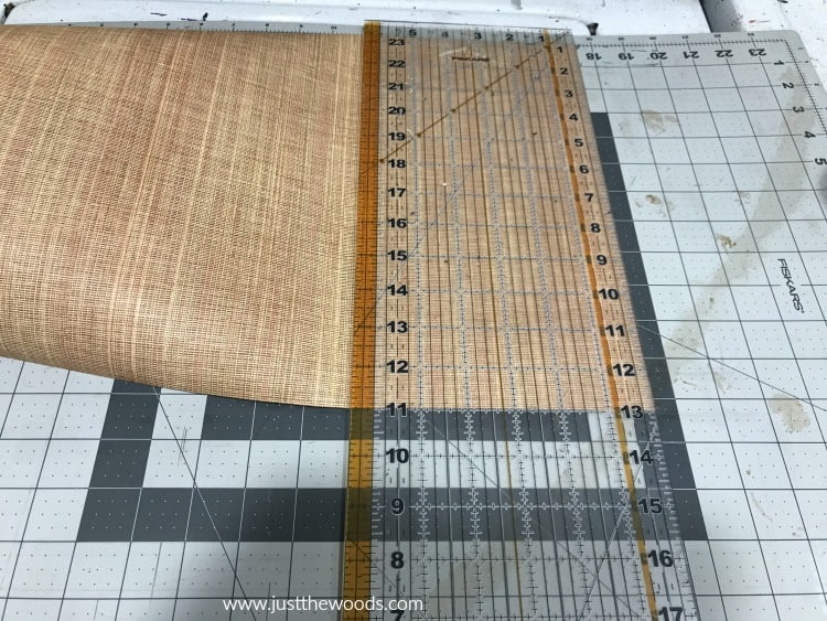 cutting mat and plastic ruler to trim paper