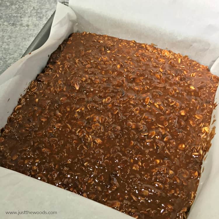 chocolate oatmeal bar mixture in parchment paper lined pan