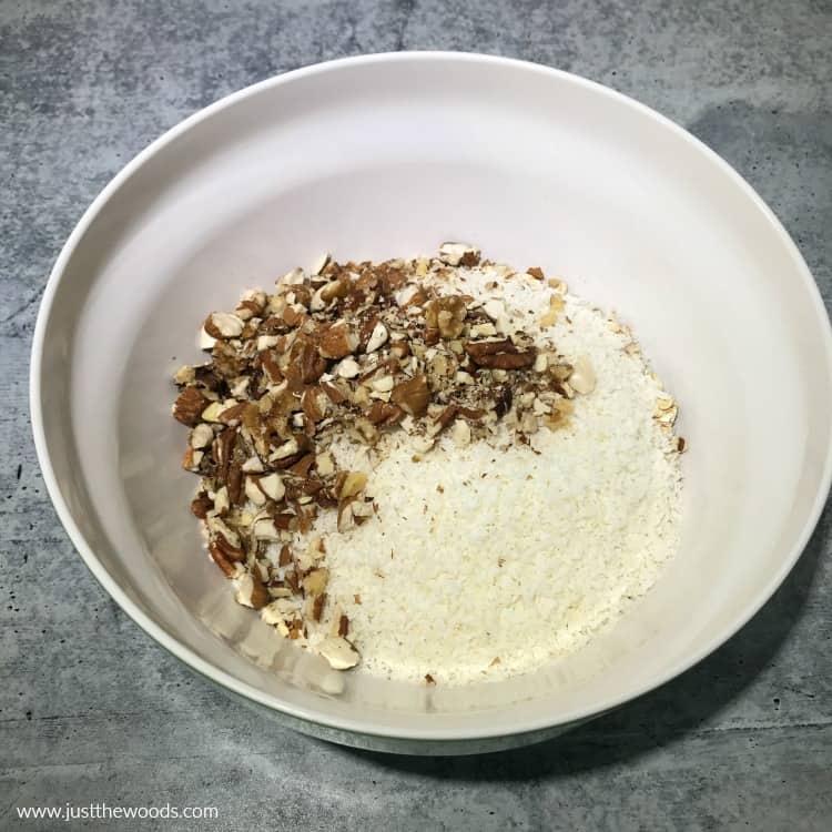 making oat bars with nuts, nuts, coconut and oats in bowl