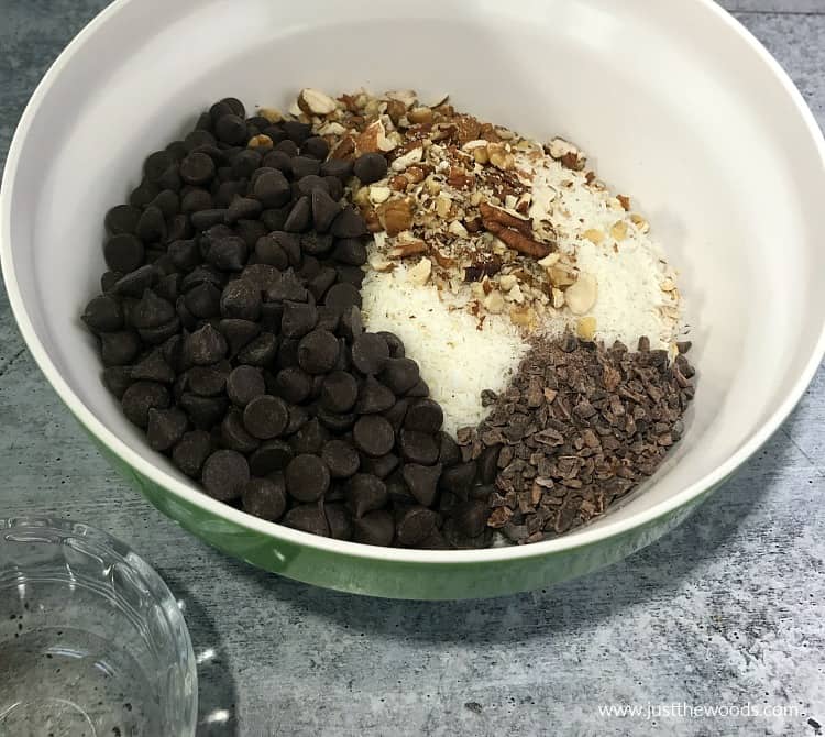 chocolate chips in bowl with nuts, cacao, coconut, how to make chocolate chip oatmeal bars
