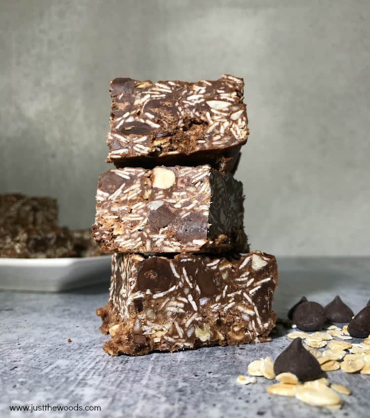 healthy peanut butter chocolate oat bars, 3 oatmeal bars stacked on one another, gray background, food photography, no bake chocolate oat bars