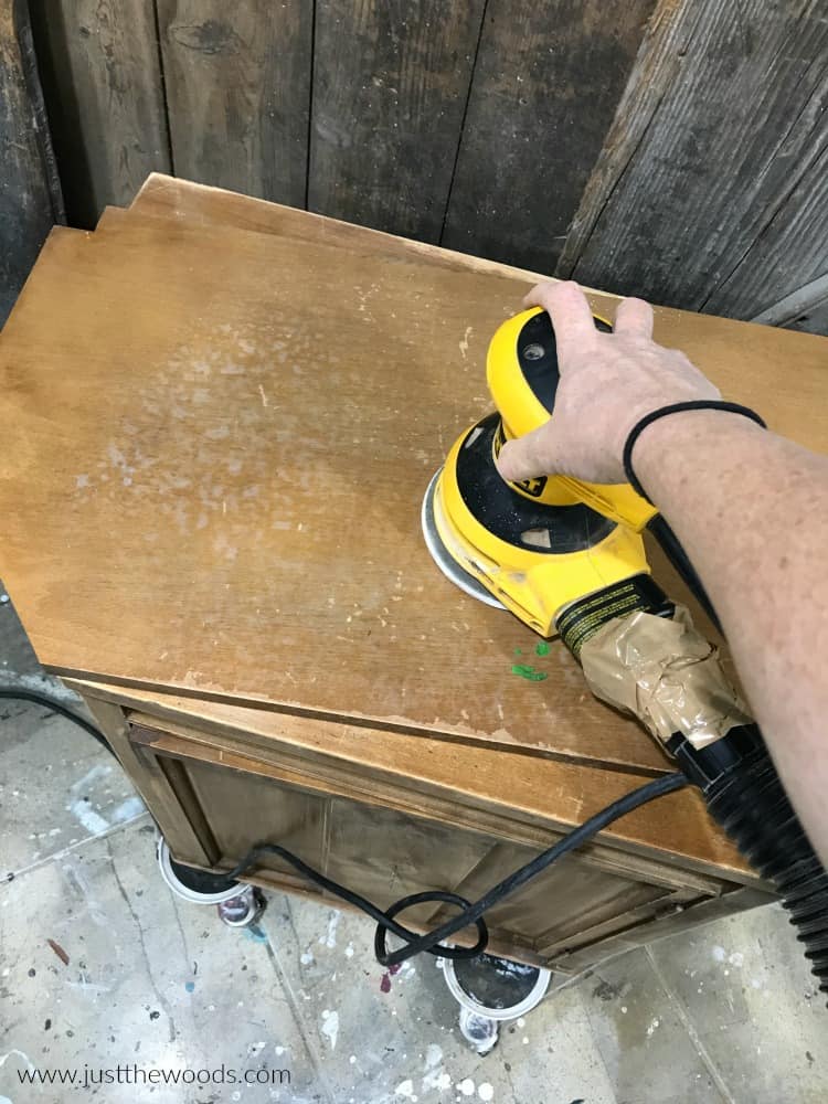 sanding wood furniture with electric sander, orbital sander