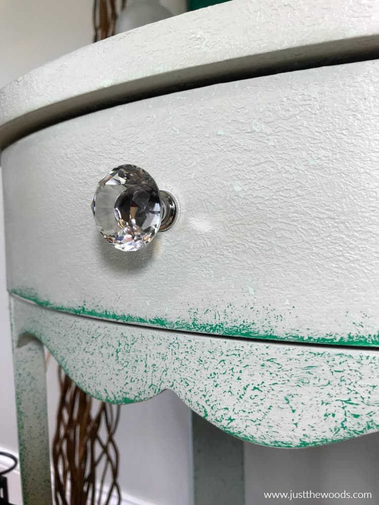 close up painted table with layered texture and clear crystal knob