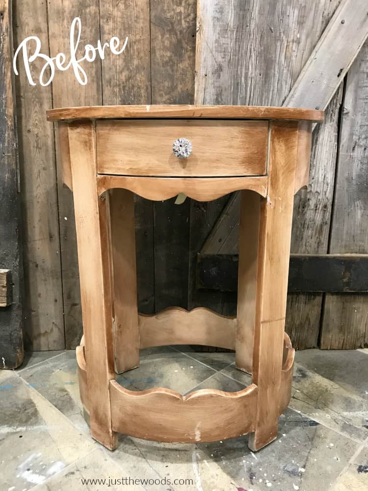 light brown round wood table with clear knob