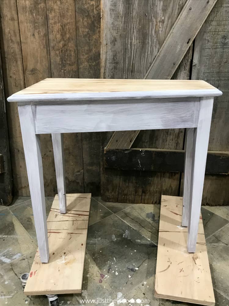 wood table painted with white primer before black furniture paint