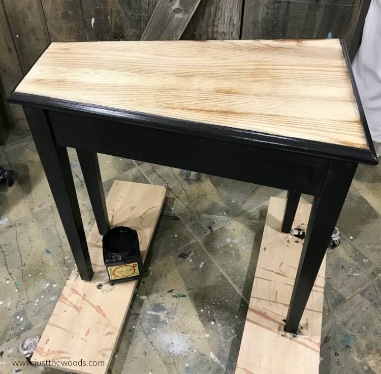 black paint on wood table with wood grain