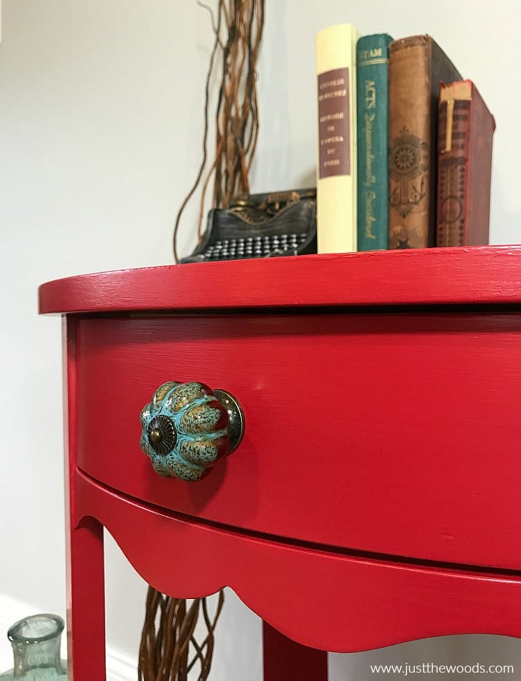 red painted drawer with blue knob, bold red painted table