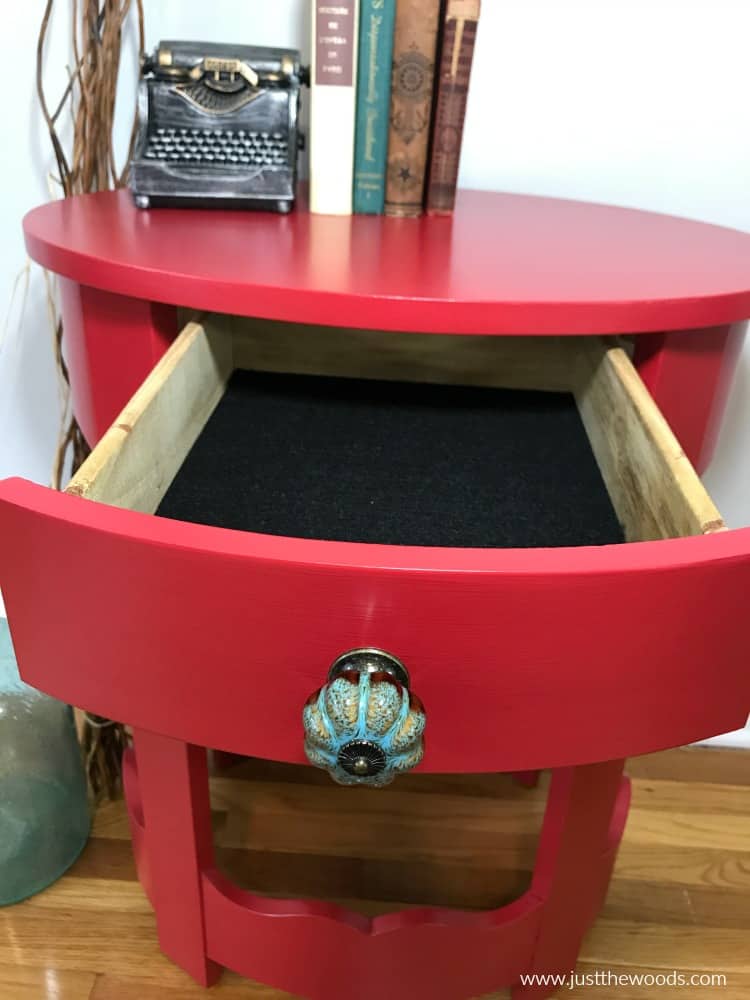 red table with blue knob, black felt liner red table