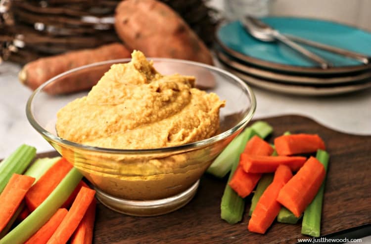 homemade hummus in bowl with carrots and celery