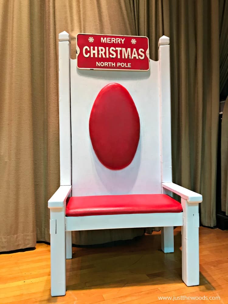 santa chair makeover with white paint on wood and red paint on fabric with metal christmas sign