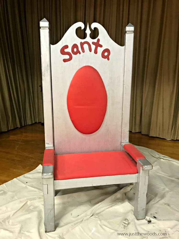 wooden chair with silver spray paint and dirty red fabric