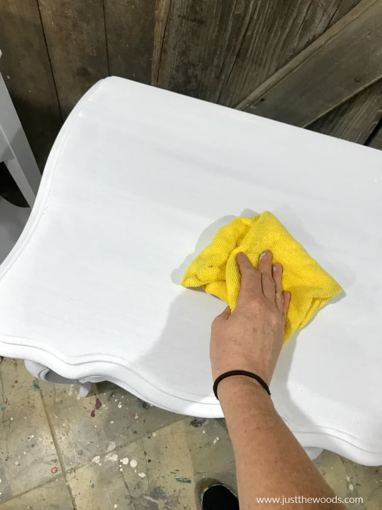 remove dust from white painted table with yellow lint free cloth