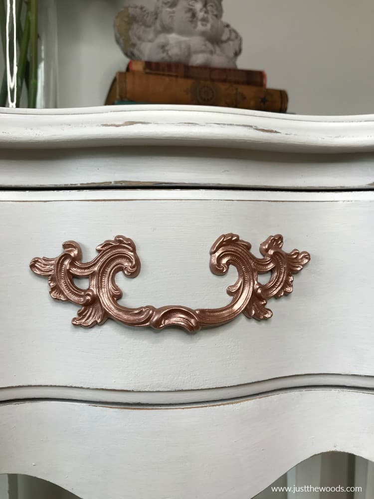 white distressed painted furniture with metallic paint hardware