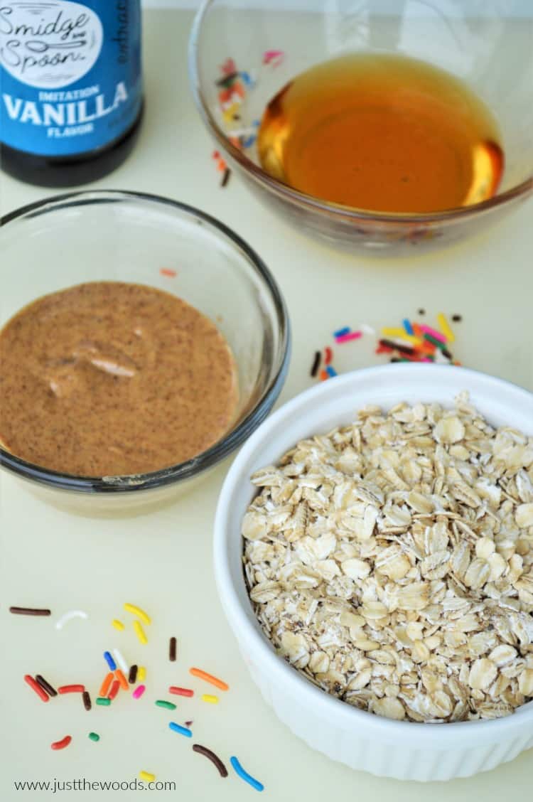 cookie dough ball ingredients, bowls of nut butter, honey and oats