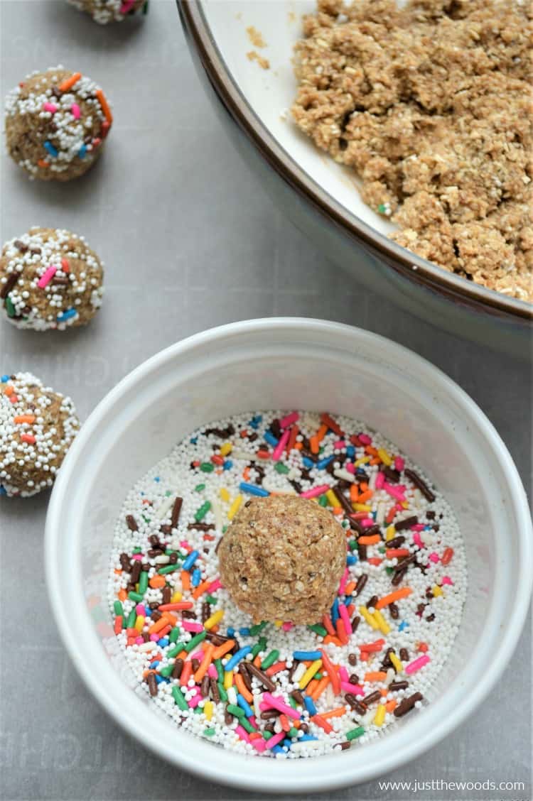 cookie dough ball in bowl of rainbow sprinkles