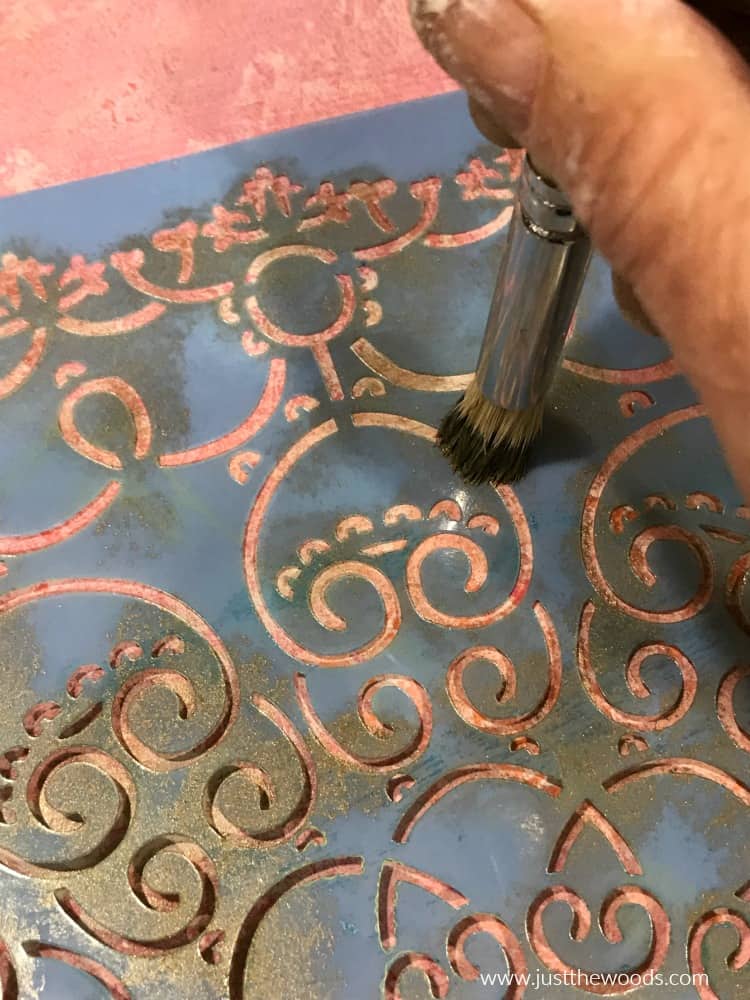 close up of stenciling metallic paint 