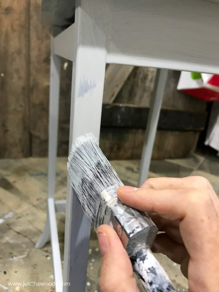 painting furniture leg with off white paint