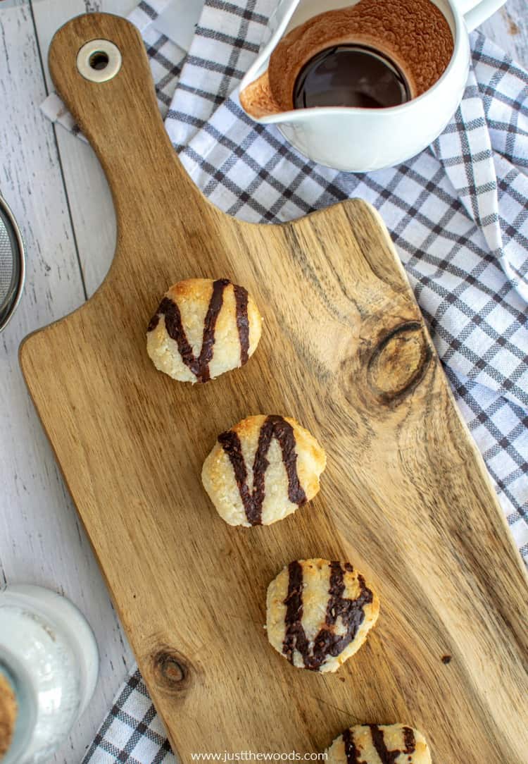 homemade gluten free macaroons on wooden board with chocolate sauce