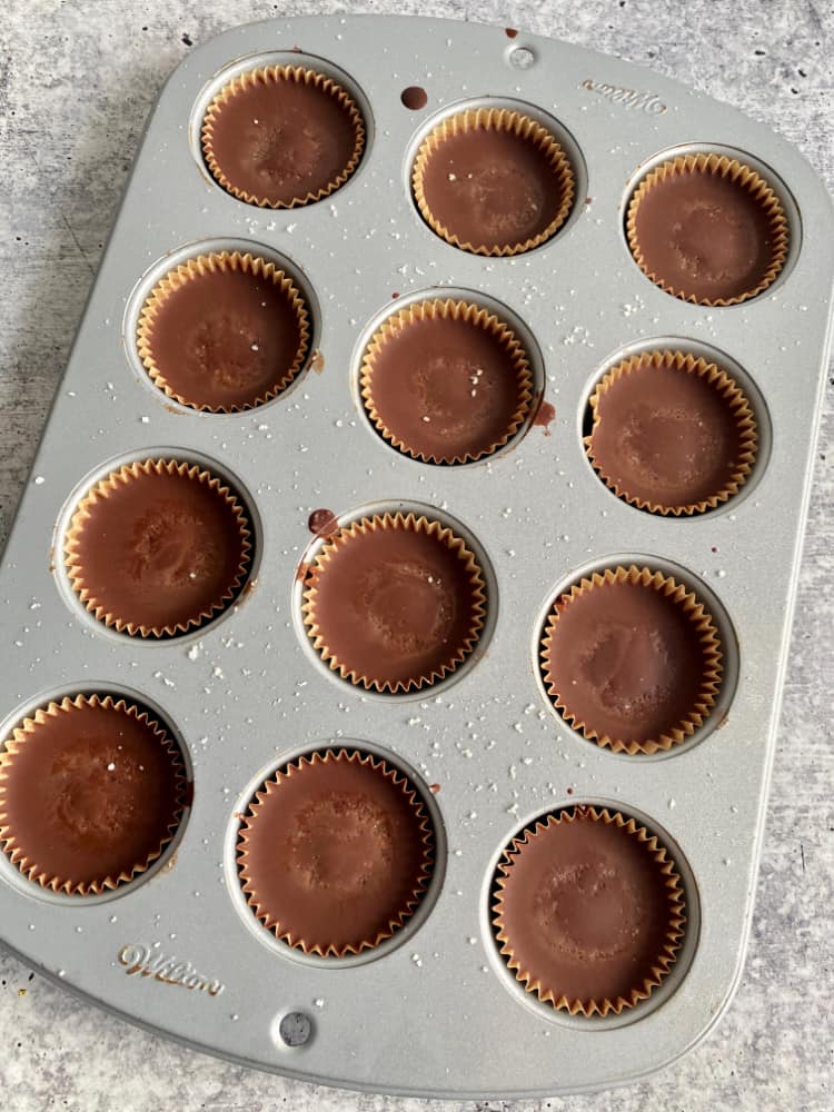no bake chocolate cups with cashew butter in muffin pan