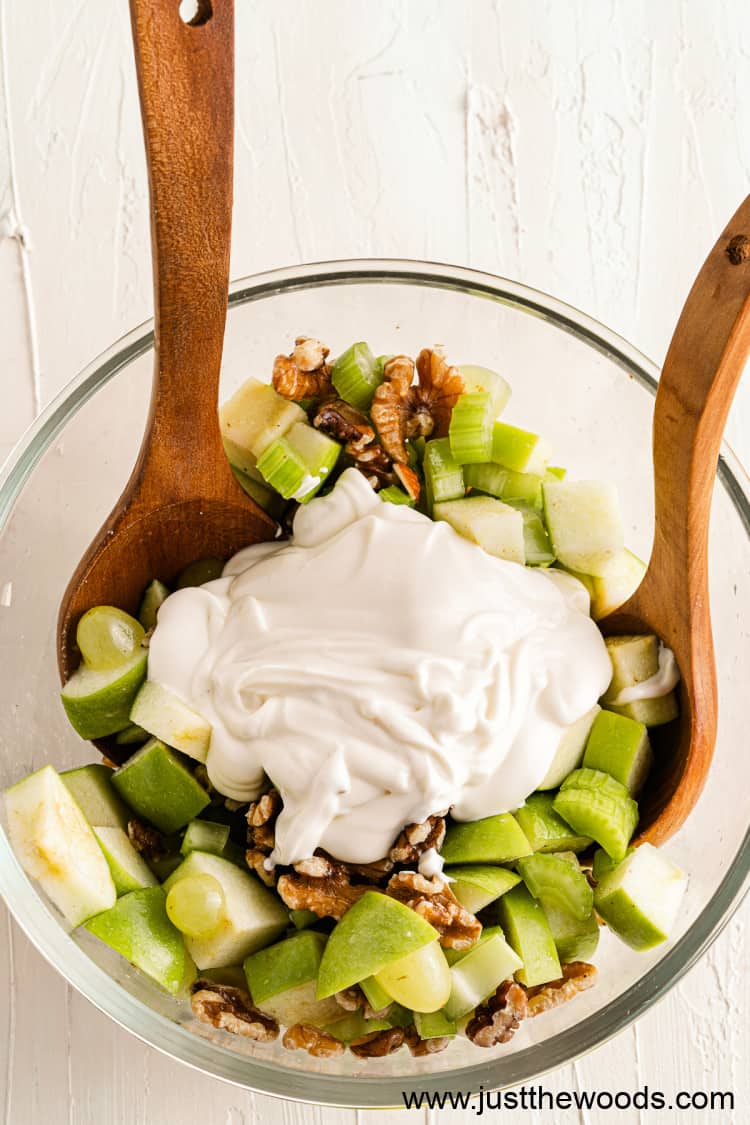 easy Waldorf salad with apples and mayo in bowl with wooden spoons