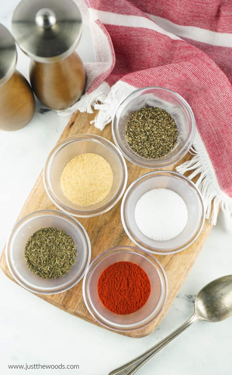 homemade steak rub spices in individual dishes on wooden board