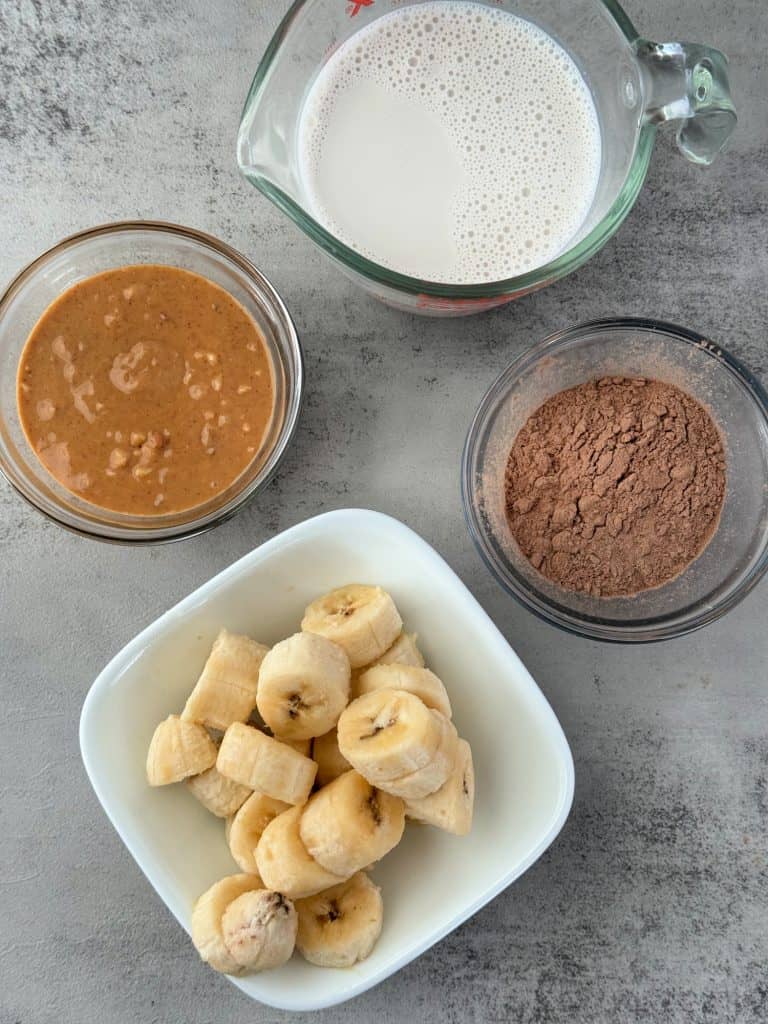 ingredients to make a healthy crunchy peanut butter banana smoothie 