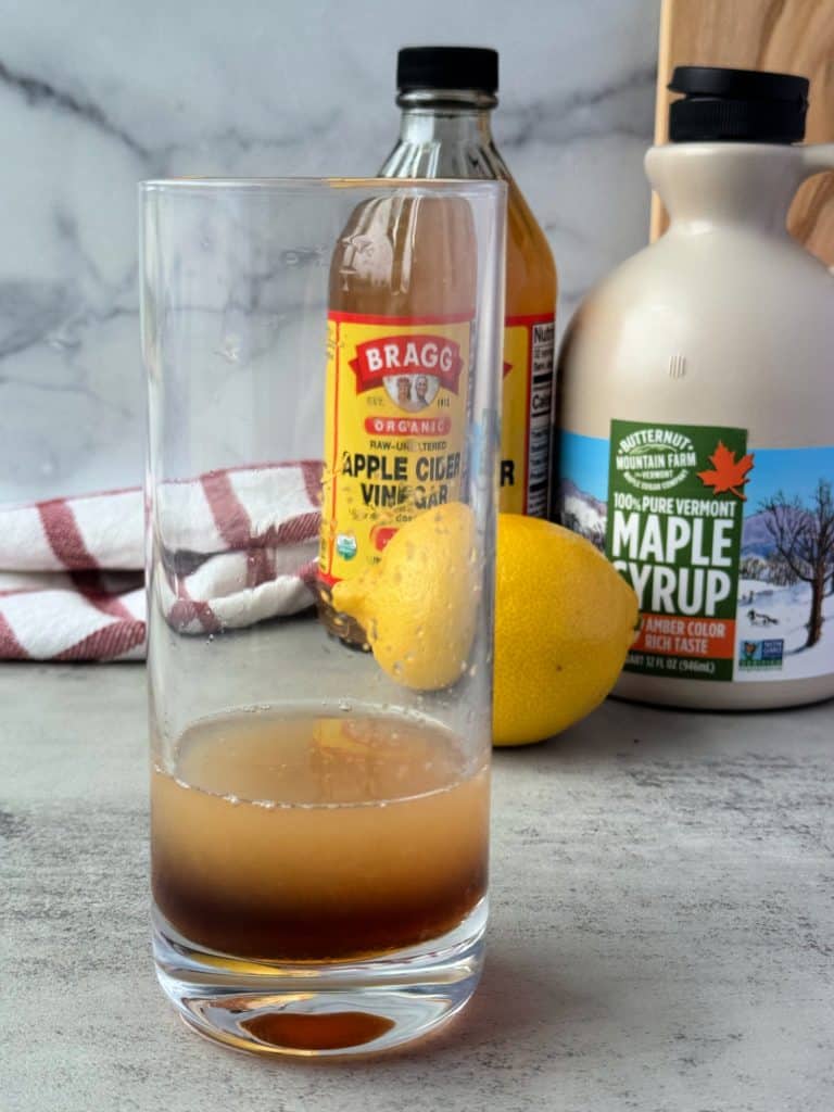 acv, maple syrup and lemon juice in tall glass 