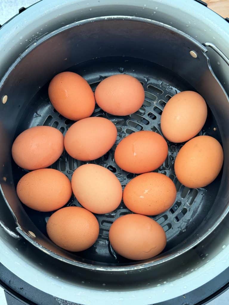 large brown eggs in air fryer basket 