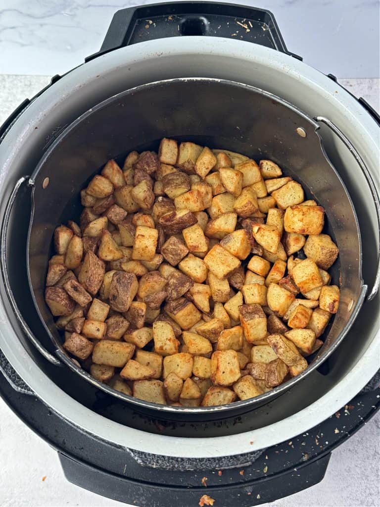 crispy potatoes in air fryer basket 