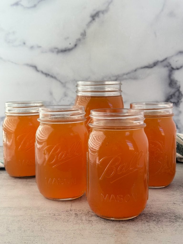 homemade Ninja Foodi Chicken Broth in mason jars 