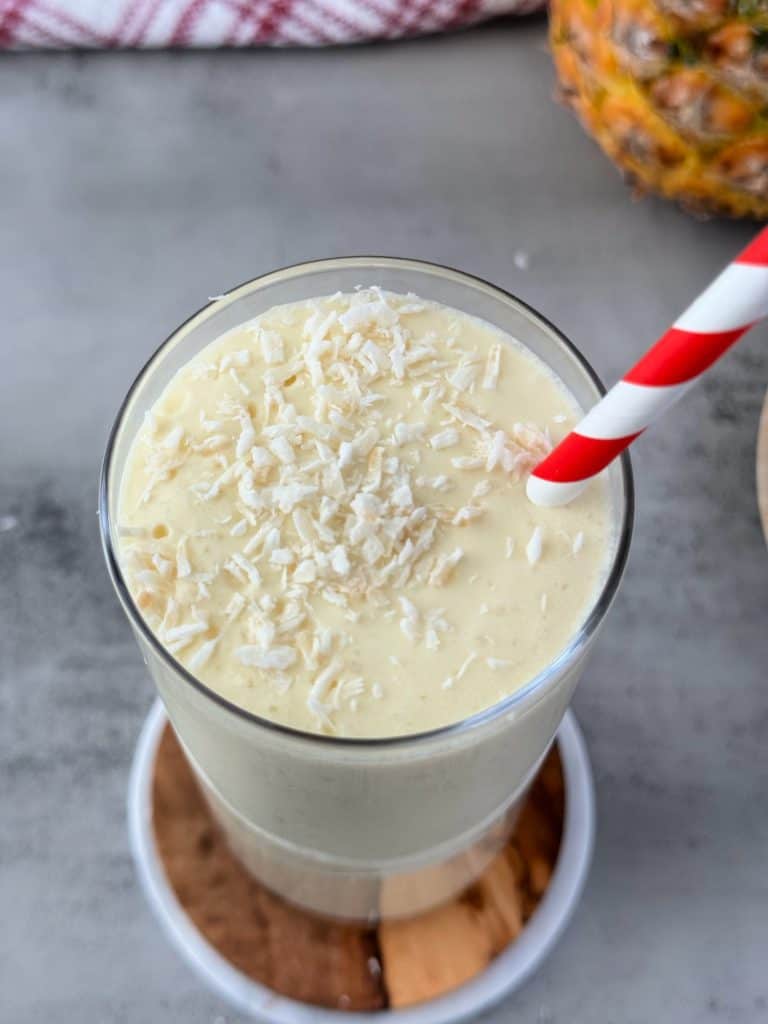 shredded coconut on creamy  Pineapple mango Coconut Smoothie