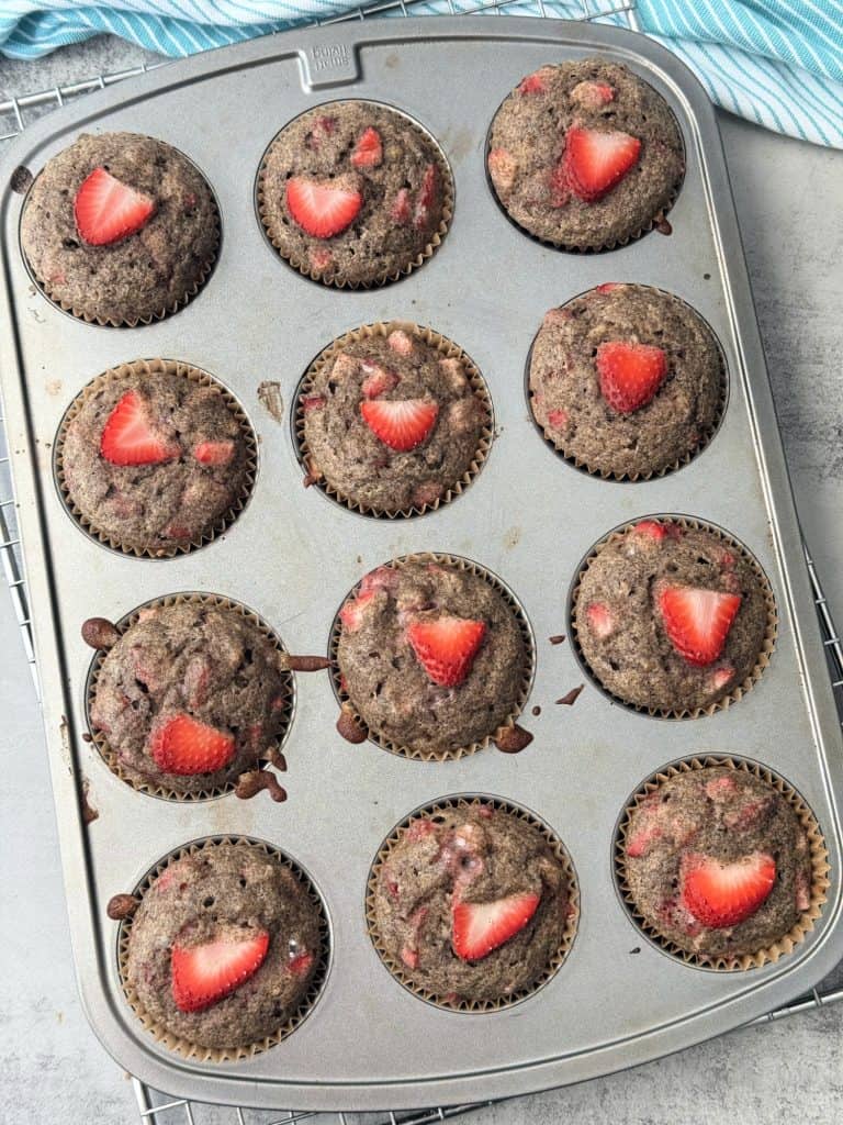 baked strawberry and banana muffins in muffin pan 