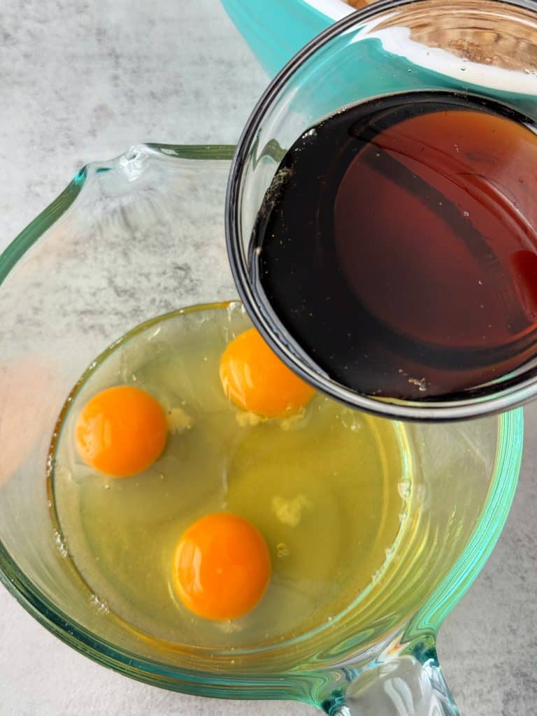 pour maple syrup into eggs