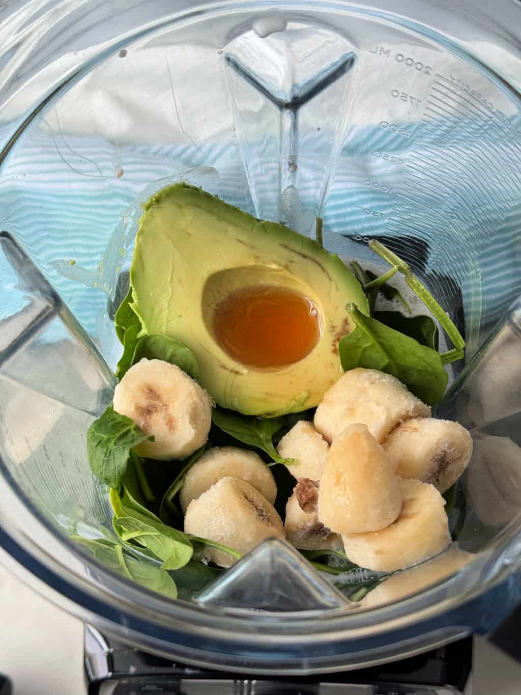 frozen banana and avocado with spinach in blender