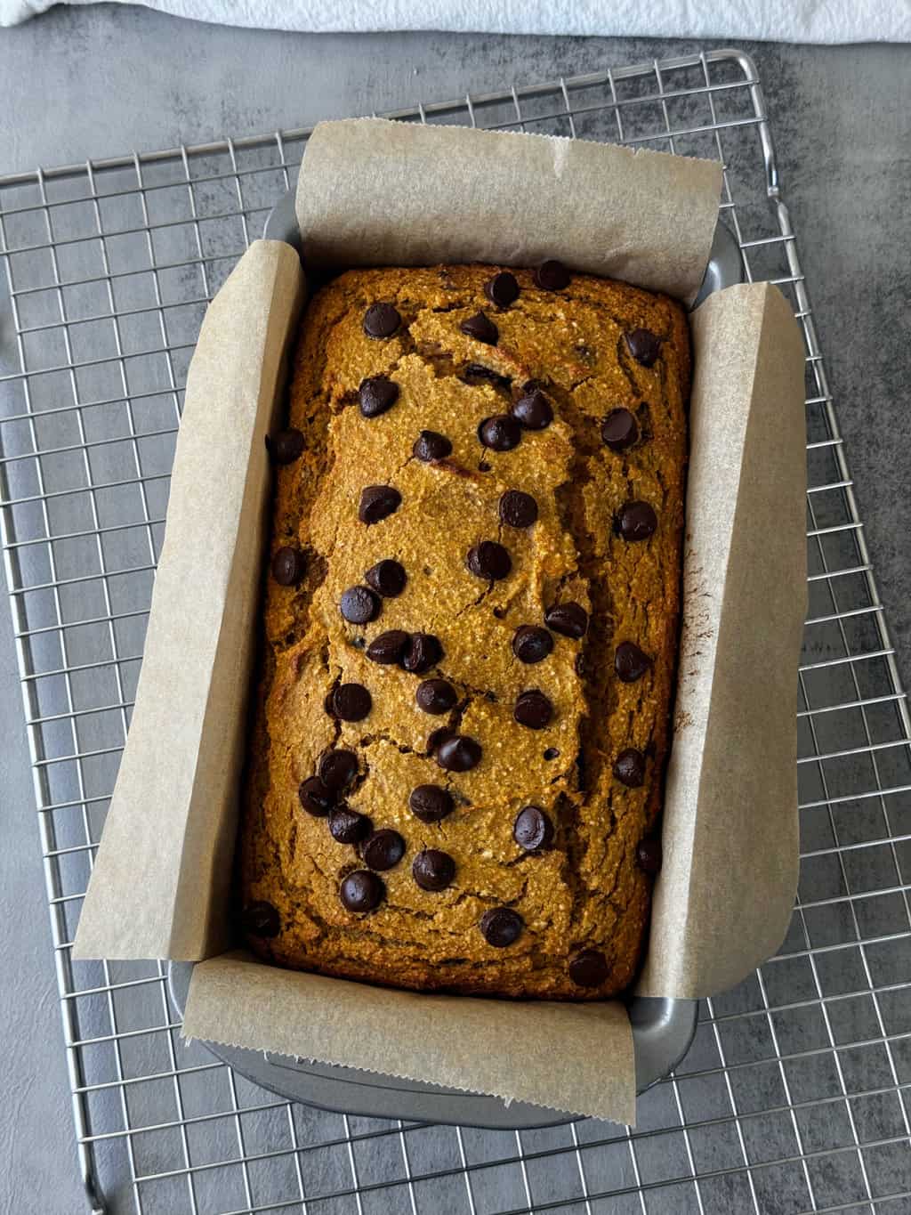 baked pumpkin bread in loaf pan on wire rack