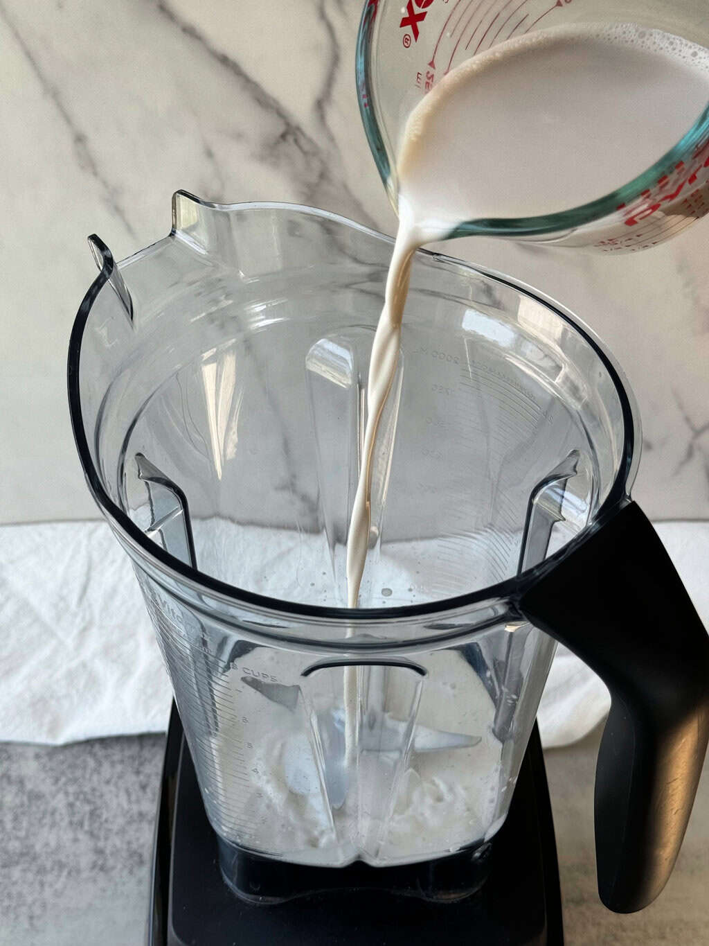 pour almond milk in blender