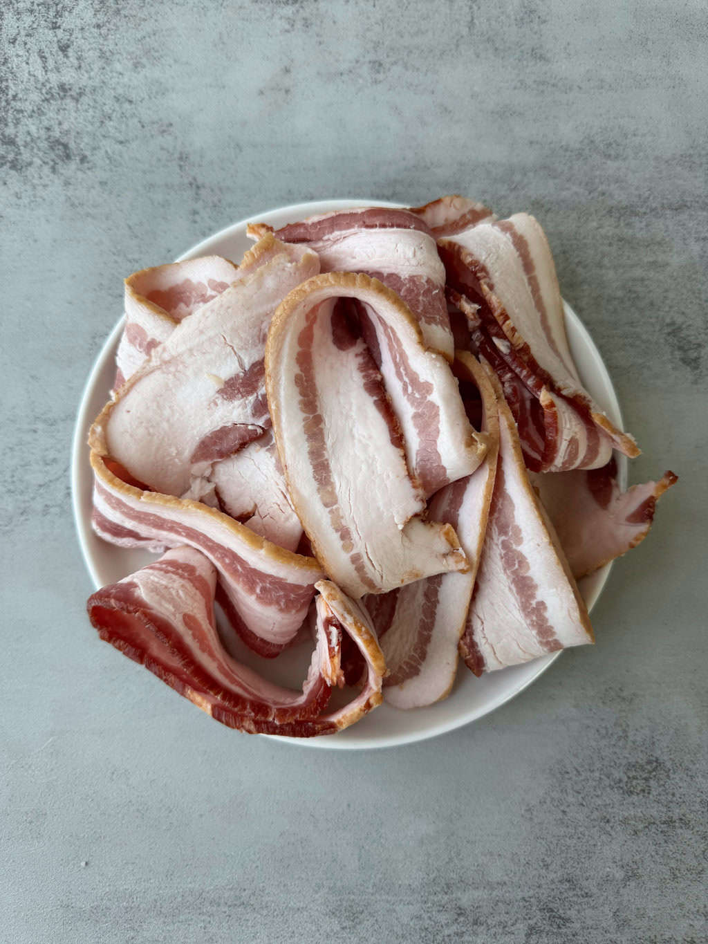raw bacon on plate