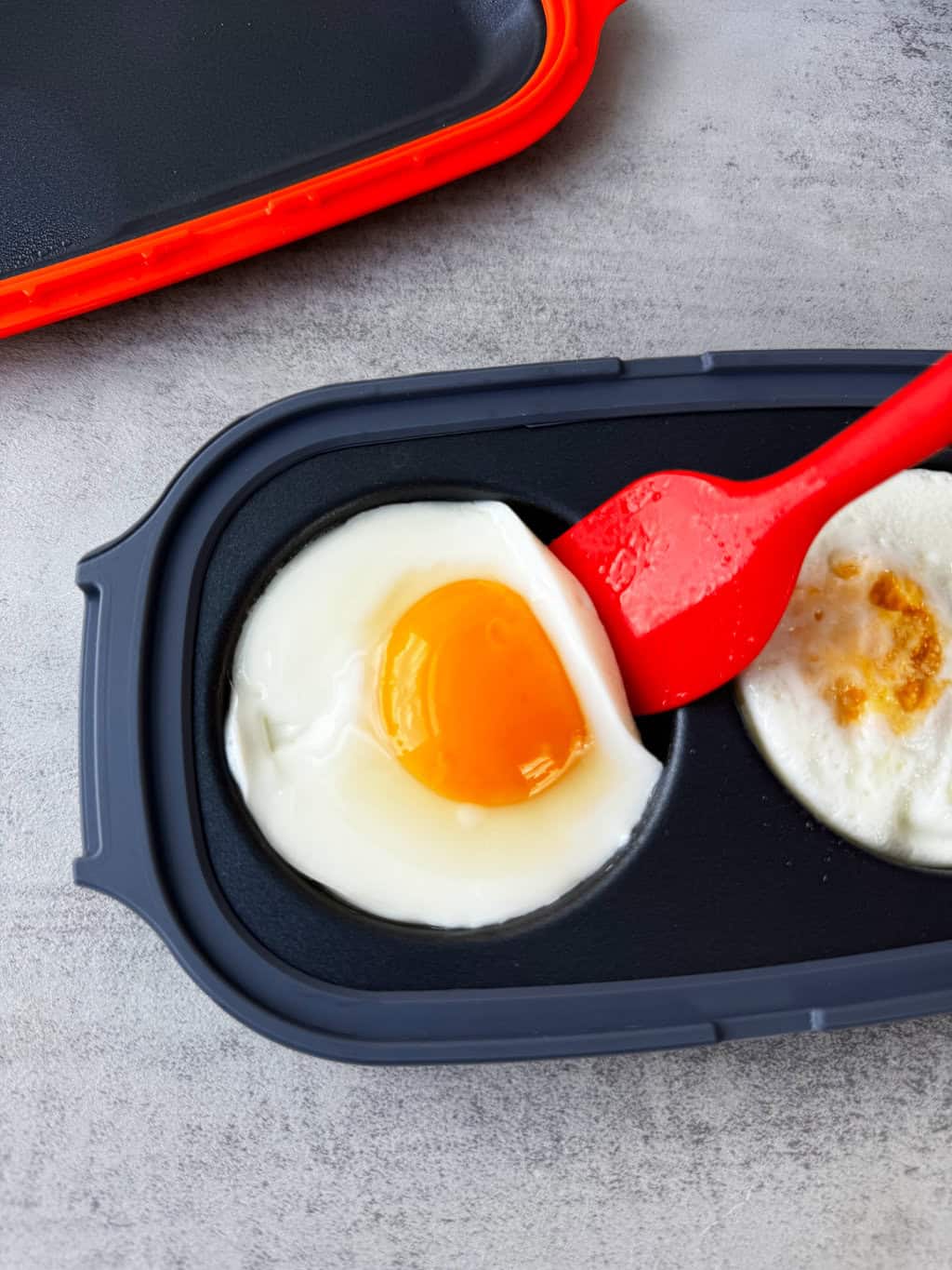spatula flipping eggs over in cooker to get even cooking