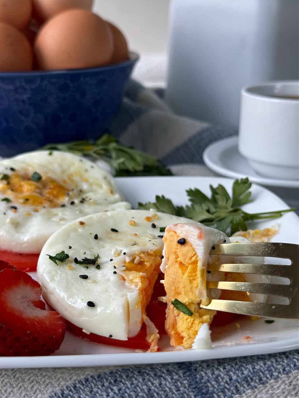 close up of cooked eggs ok a fork with yolk cooked