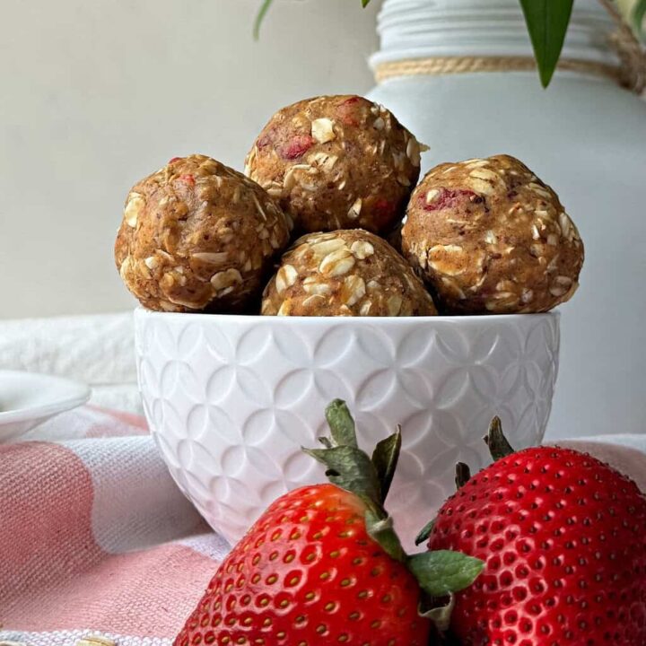 oat protein ball recipe with peanut butter and strawberries in a white dish