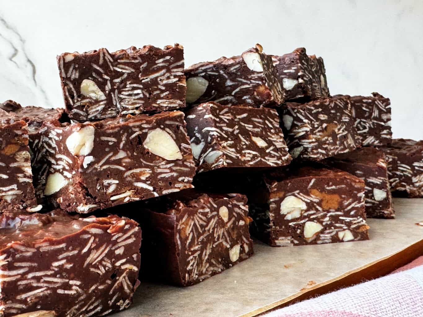 No Bake Chocolate Oatmeal Bars Recipe with Almonds stacked on parchment paper