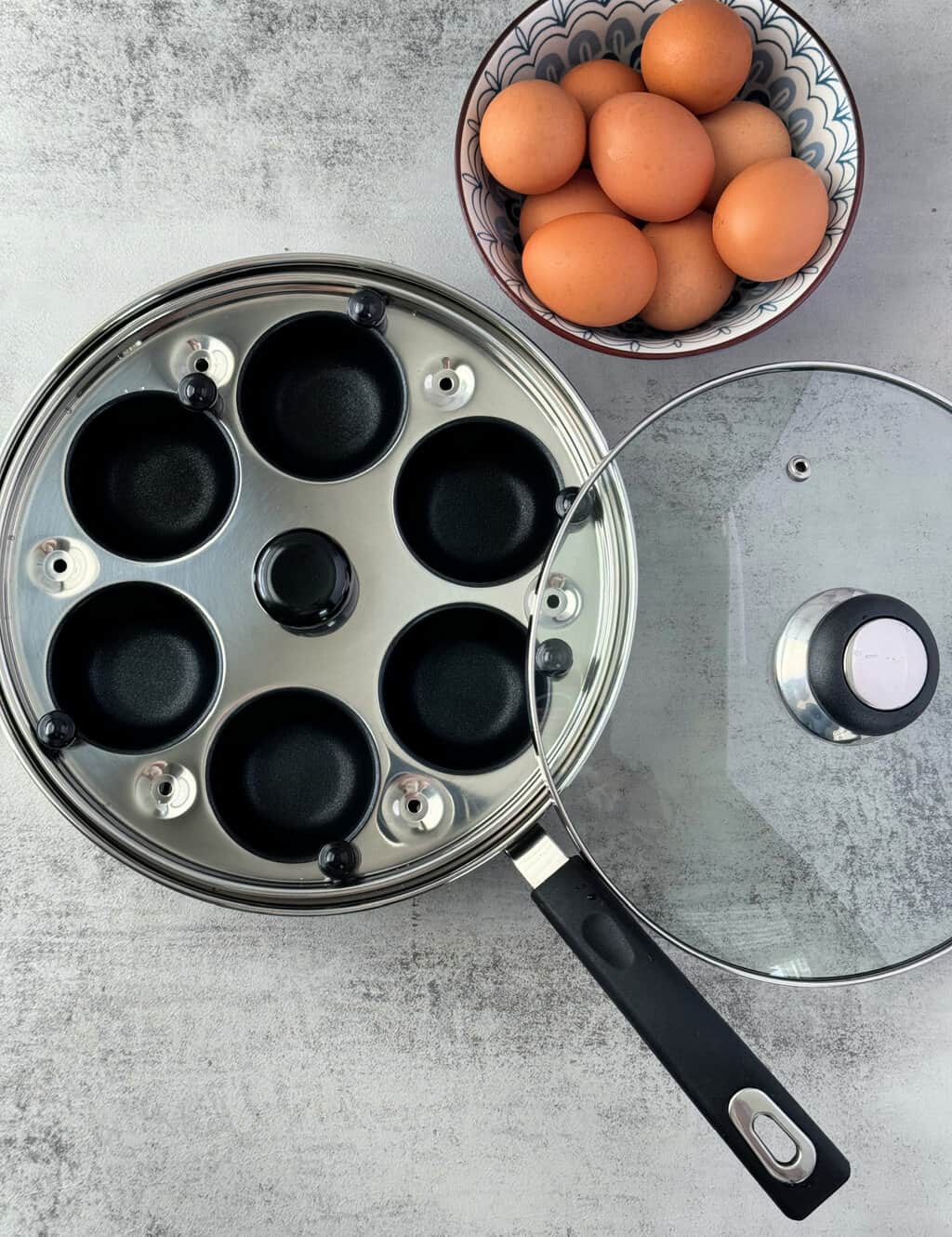 egg poacher pan with bowl of brown eggs